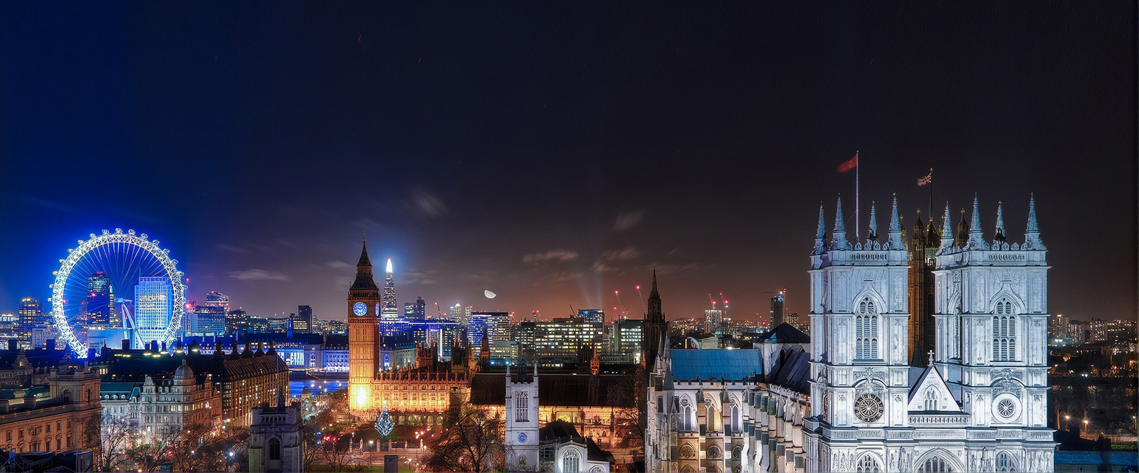 London skyline at night with the London Eye, Big Ben and Westminster Abbey
